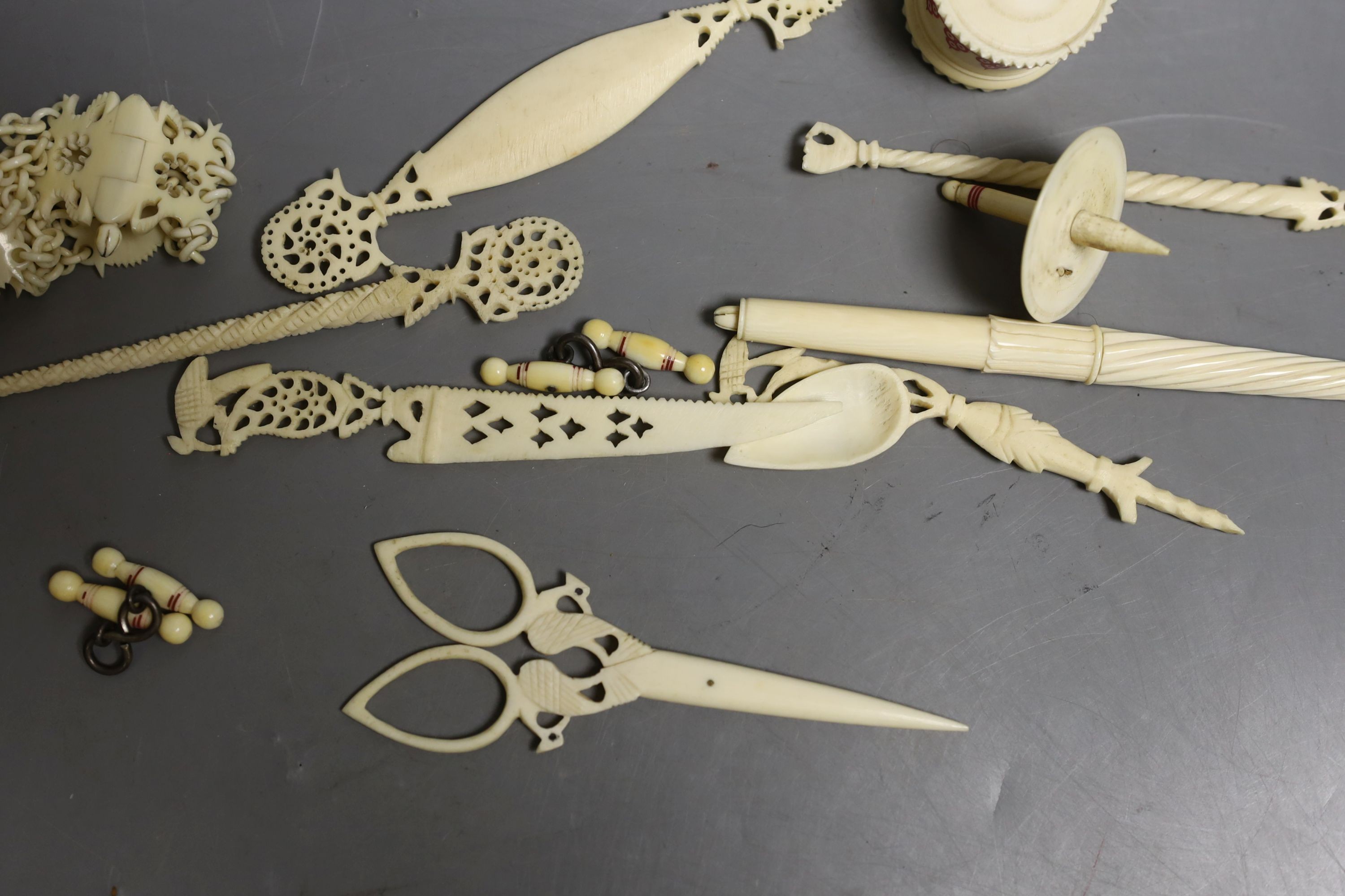 A group of 19th century/early 20th century carved ivory chains, sewing accessories, bracelets etc.